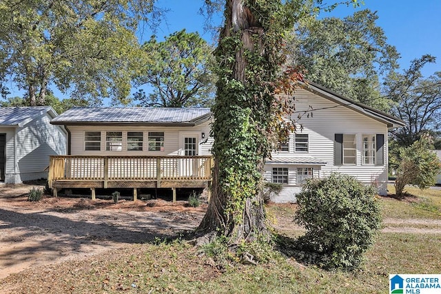 back of house featuring a wooden deck