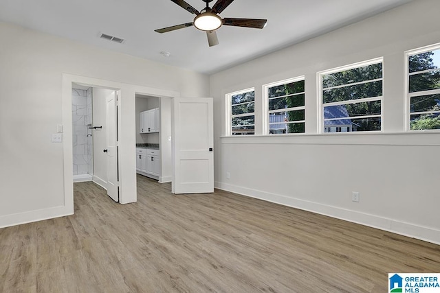 unfurnished bedroom featuring light hardwood / wood-style floors, multiple windows, and ceiling fan