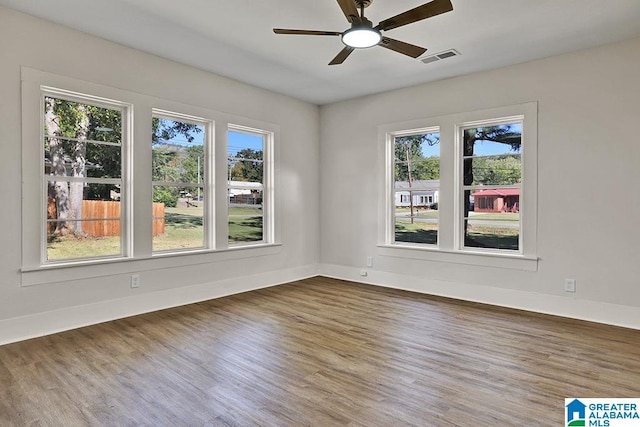 spare room with dark hardwood / wood-style floors and ceiling fan