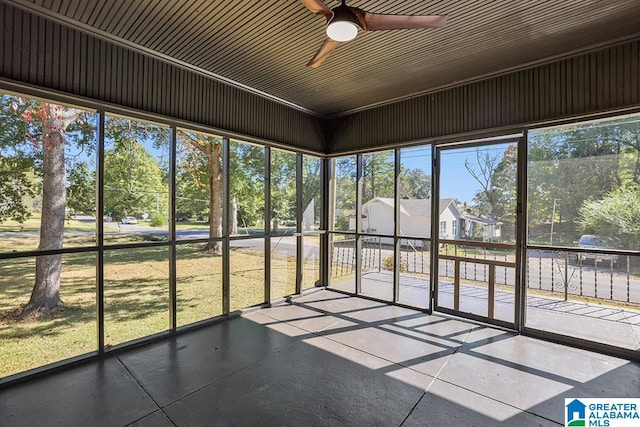 unfurnished sunroom featuring ceiling fan