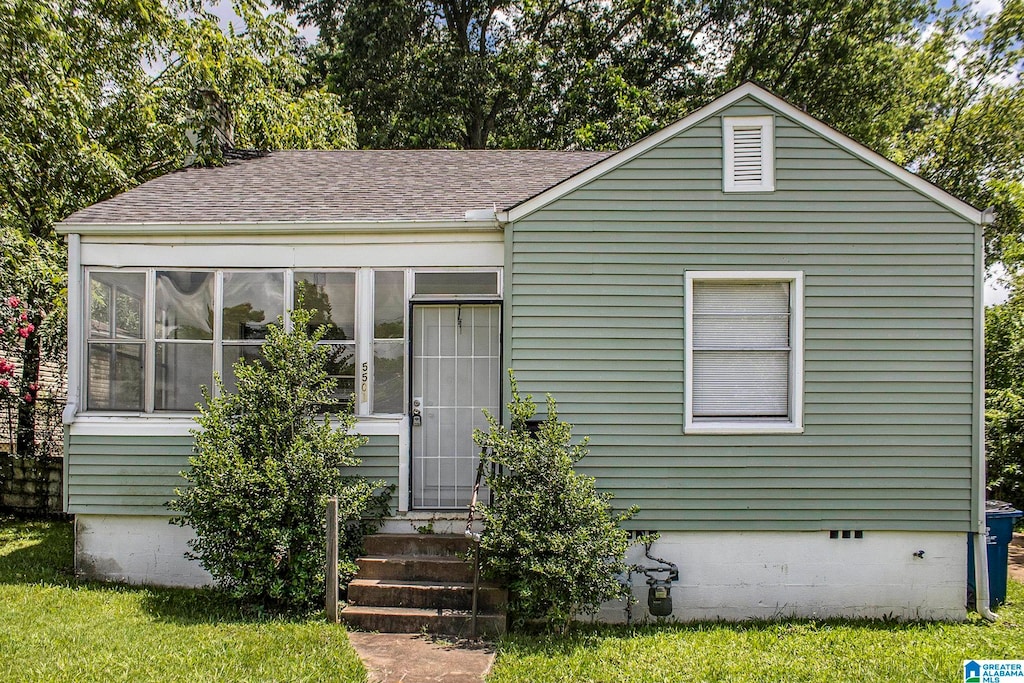 view of front of house featuring a sunroom