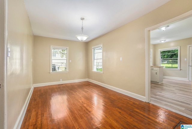 unfurnished room with hardwood / wood-style floors