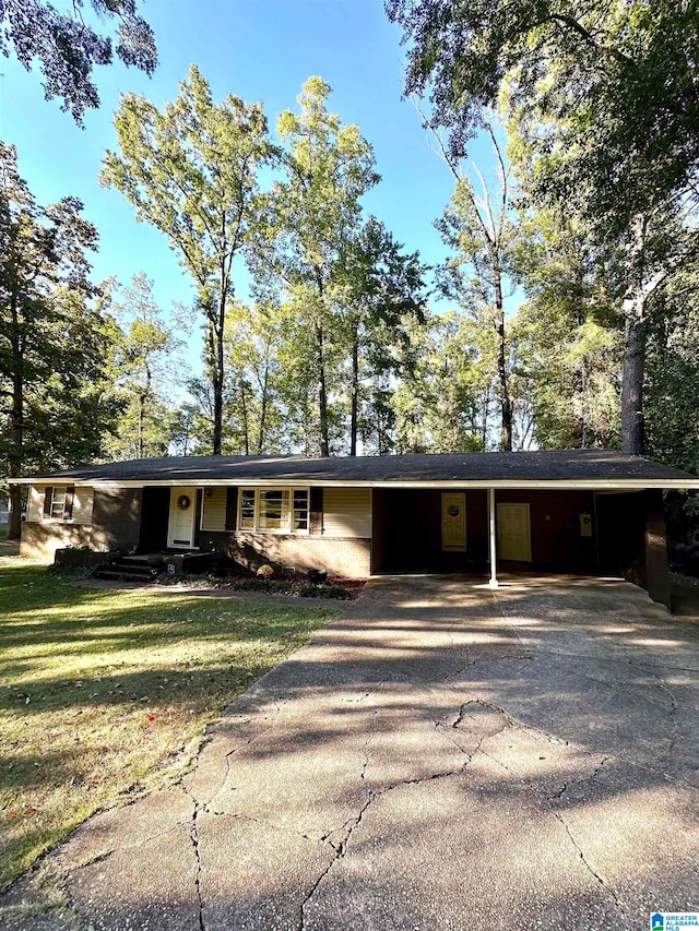 ranch-style home with a carport and a front lawn