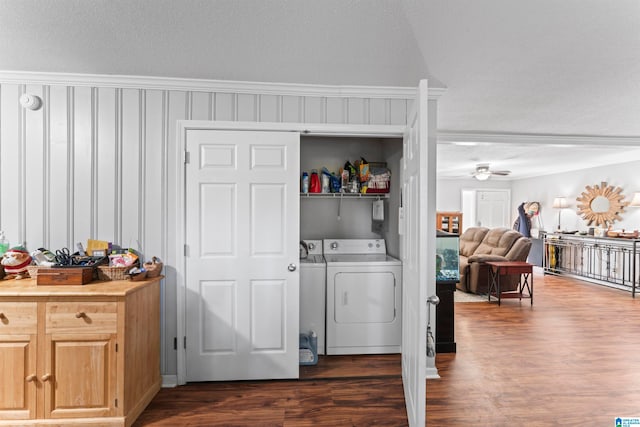 clothes washing area featuring independent washer and dryer, crown molding, a textured ceiling, and dark hardwood / wood-style flooring