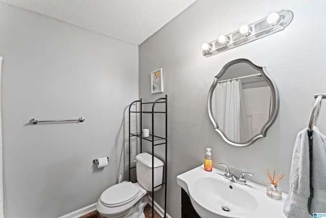 bathroom with sink, a textured ceiling, and toilet