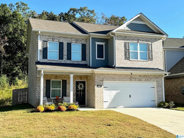 view of front of home with a front yard and a garage