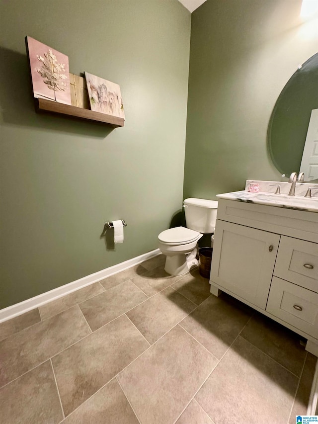 bathroom featuring vanity, toilet, and tile patterned floors