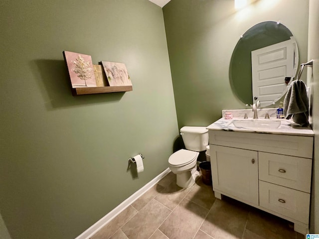 bathroom featuring toilet, vanity, and tile patterned floors