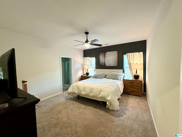 bedroom featuring light colored carpet and ceiling fan