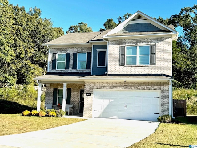 view of front of property with a front yard and a garage