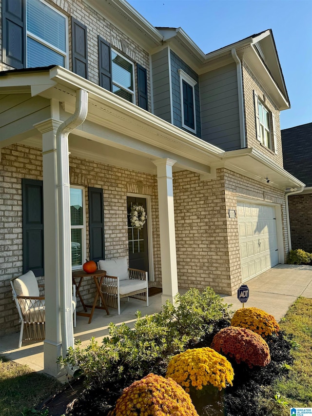 exterior space featuring a porch and a garage