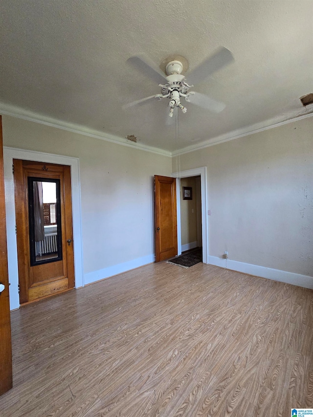 unfurnished room featuring light hardwood / wood-style floors, crown molding, a textured ceiling, and ceiling fan