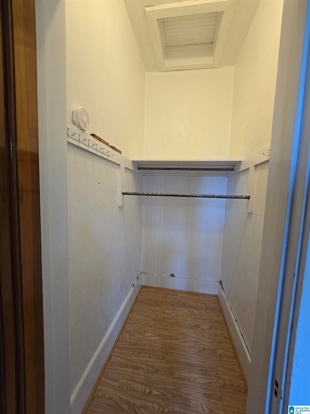 walk in closet featuring hardwood / wood-style flooring