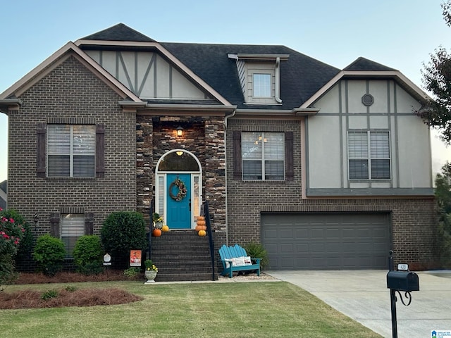 tudor house with a front yard and a garage