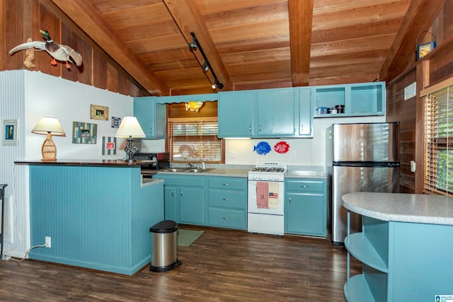 kitchen featuring white gas stove, blue cabinetry, stainless steel refrigerator, track lighting, and dark hardwood / wood-style floors