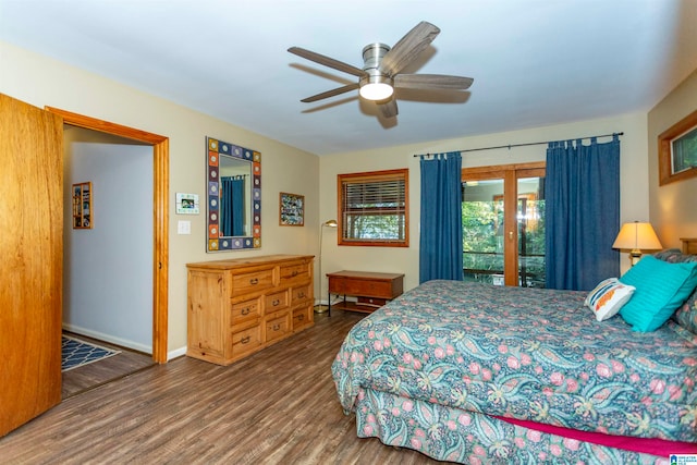 bedroom with access to outside, hardwood / wood-style floors, and ceiling fan