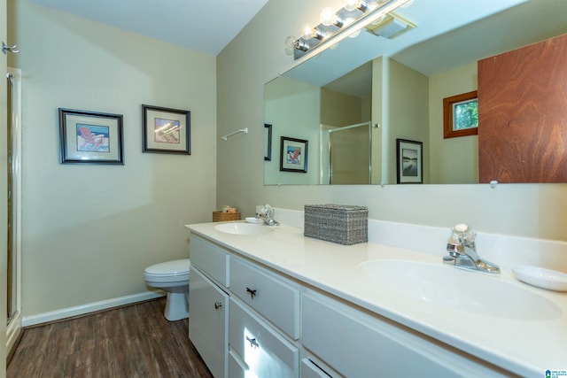 bathroom with vanity, toilet, walk in shower, and wood-type flooring