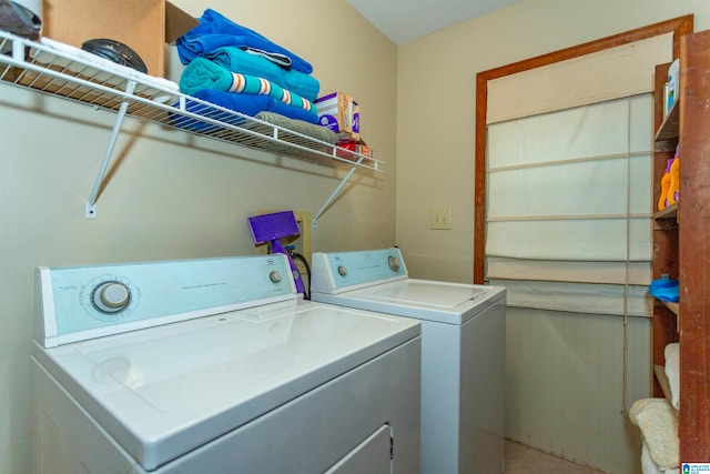 clothes washing area featuring independent washer and dryer