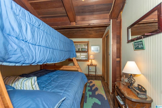 bedroom featuring wood ceiling, hardwood / wood-style flooring, and beamed ceiling