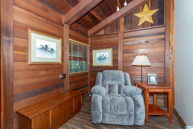 living area with wood ceiling, lofted ceiling with beams, dark hardwood / wood-style floors, and wood walls