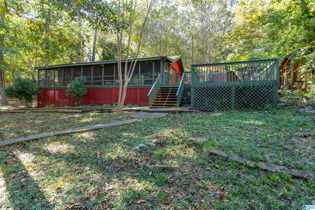 view of yard with a wooden deck and a sunroom