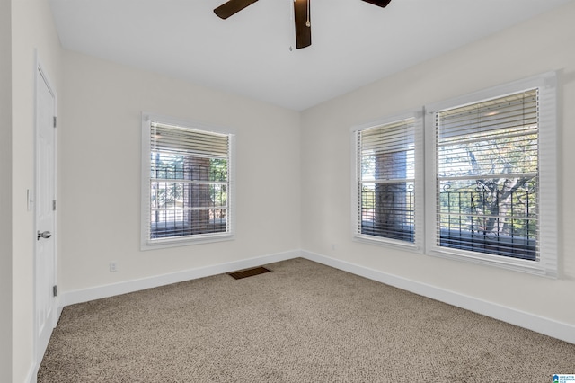 spare room featuring carpet floors and ceiling fan