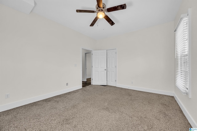 unfurnished bedroom featuring a closet, ceiling fan, and carpet flooring