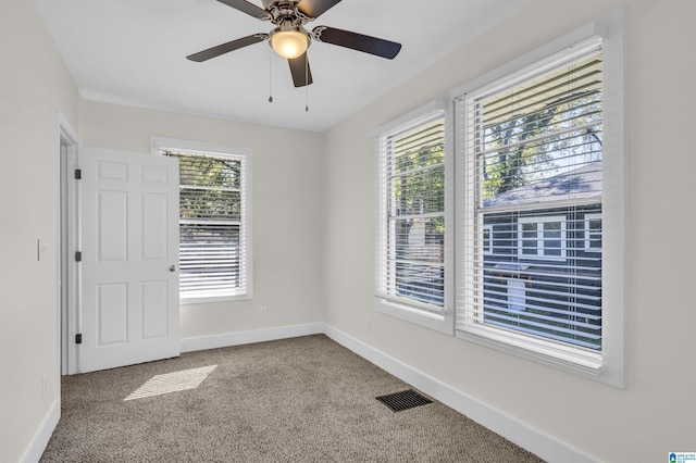 spare room featuring ceiling fan and carpet floors