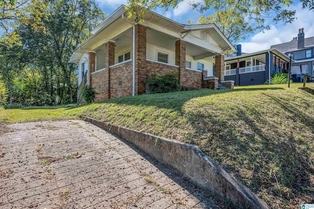 exterior space with a porch and a front yard