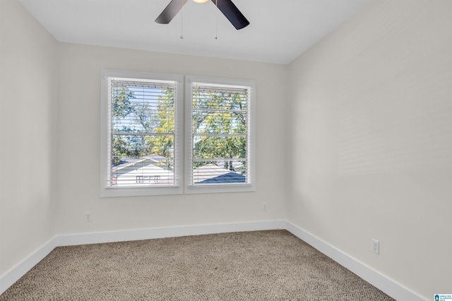 spare room with ceiling fan and carpet