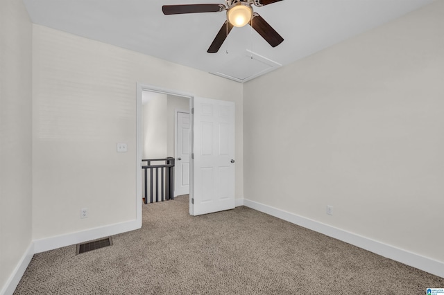 spare room featuring ceiling fan and carpet flooring