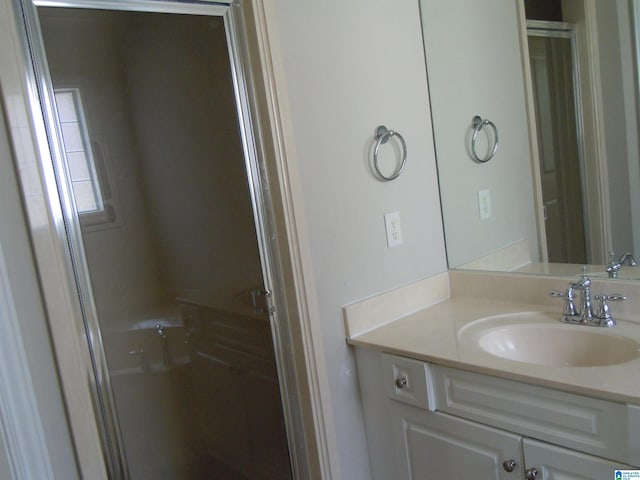 bathroom with vanity and an enclosed shower