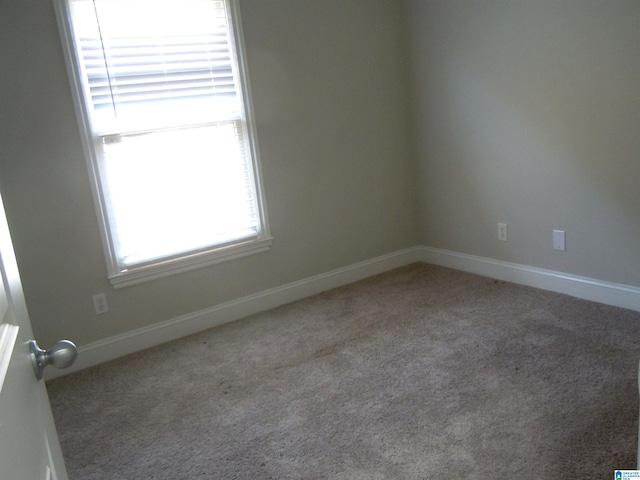 unfurnished room featuring light colored carpet