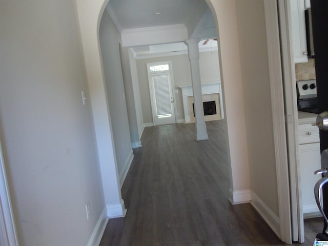 corridor with dark wood-type flooring and ornamental molding