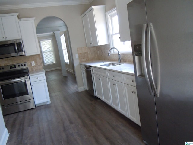 kitchen featuring white cabinetry, tasteful backsplash, appliances with stainless steel finishes, and plenty of natural light