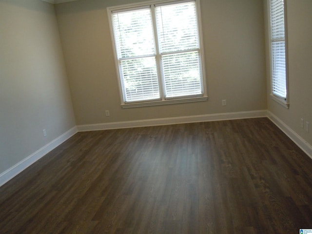 empty room with dark hardwood / wood-style floors