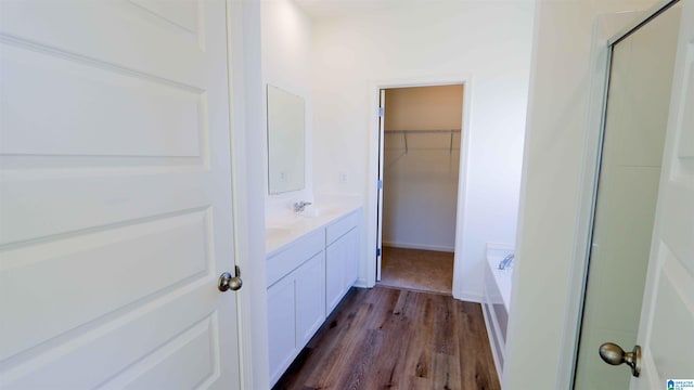 bathroom featuring hardwood / wood-style floors, vanity, and shower with separate bathtub