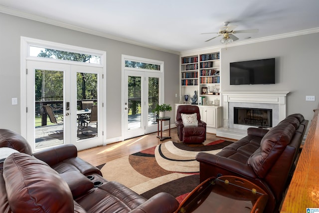 living room with french doors, light hardwood / wood-style floors, crown molding, and ceiling fan