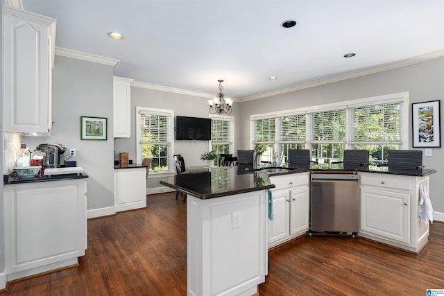 kitchen featuring stainless steel dishwasher, white cabinetry, dark hardwood / wood-style flooring, and plenty of natural light