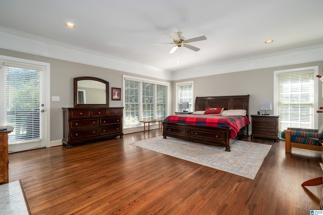 bedroom featuring dark hardwood / wood-style flooring, multiple windows, and ceiling fan