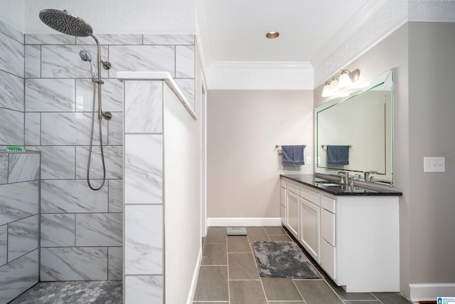 bathroom featuring vanity, tiled shower, crown molding, and tile patterned flooring