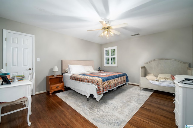 bedroom with dark hardwood / wood-style floors and ceiling fan