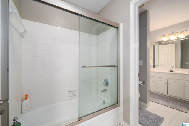 full bathroom with vanity, enclosed tub / shower combo, tile patterned floors, and toilet