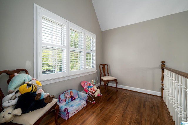 game room with dark hardwood / wood-style floors and vaulted ceiling