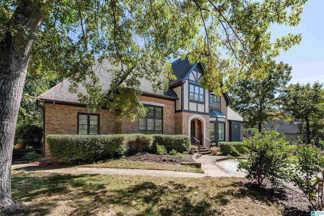 tudor house with a front yard