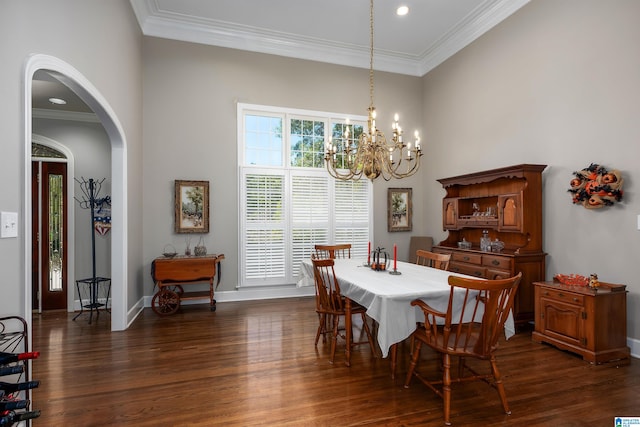 dining area featuring crown molding, a notable chandelier, and dark hardwood / wood-style flooring