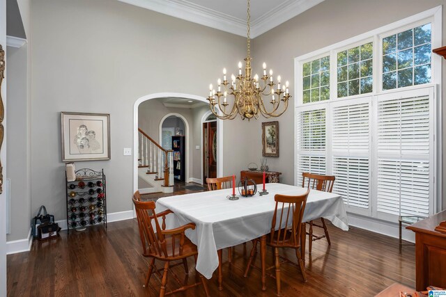 dining space featuring ornamental molding, dark hardwood / wood-style floors, and a high ceiling