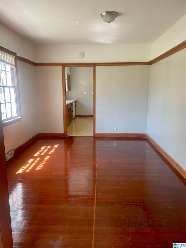 unfurnished room with hardwood / wood-style flooring