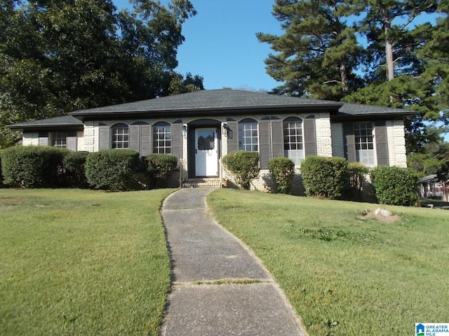 ranch-style house with a front lawn