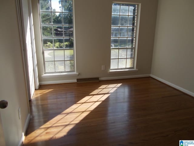 empty room with dark wood-type flooring